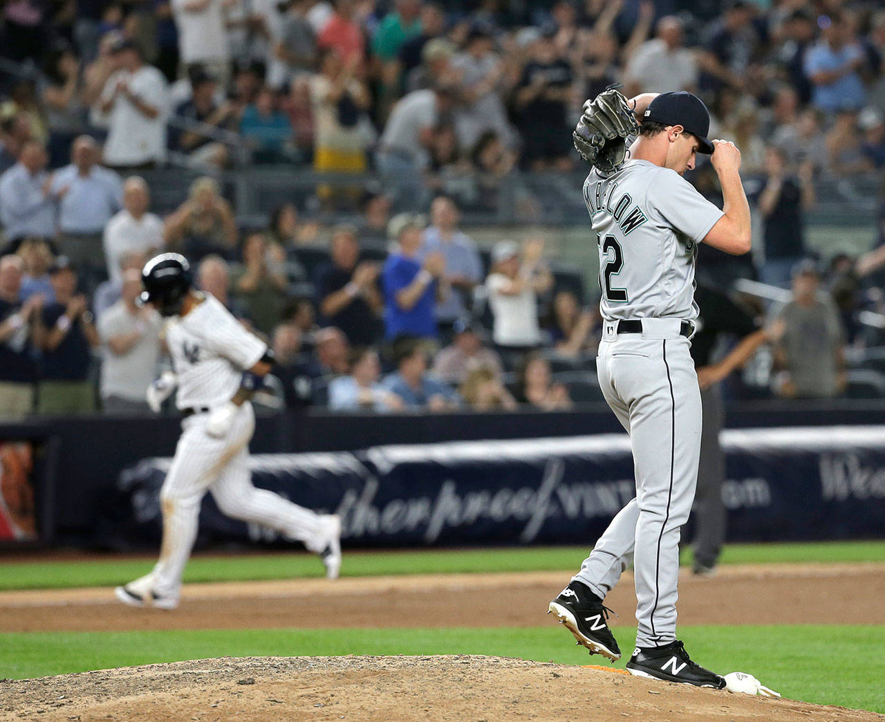 Mariners relief pitcher Nick Rumbelow (right) reacts as the Yankees’ Gleyber Torres rounds the bases after hitting a home run during the eighth inning on June 19, 2018, at Yankee Stadium in New York. (AP Photo/Seth Wenig)