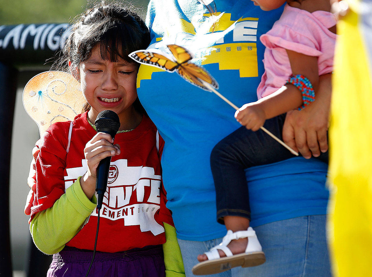 Akemi Vargas, 8, cries as she talks about being separated from her father during an immigration family separation protest in front of the Sandra Day O’Connor U.S. District Court building in Phoenix on Monday. (AP Photo/Ross Franklin)