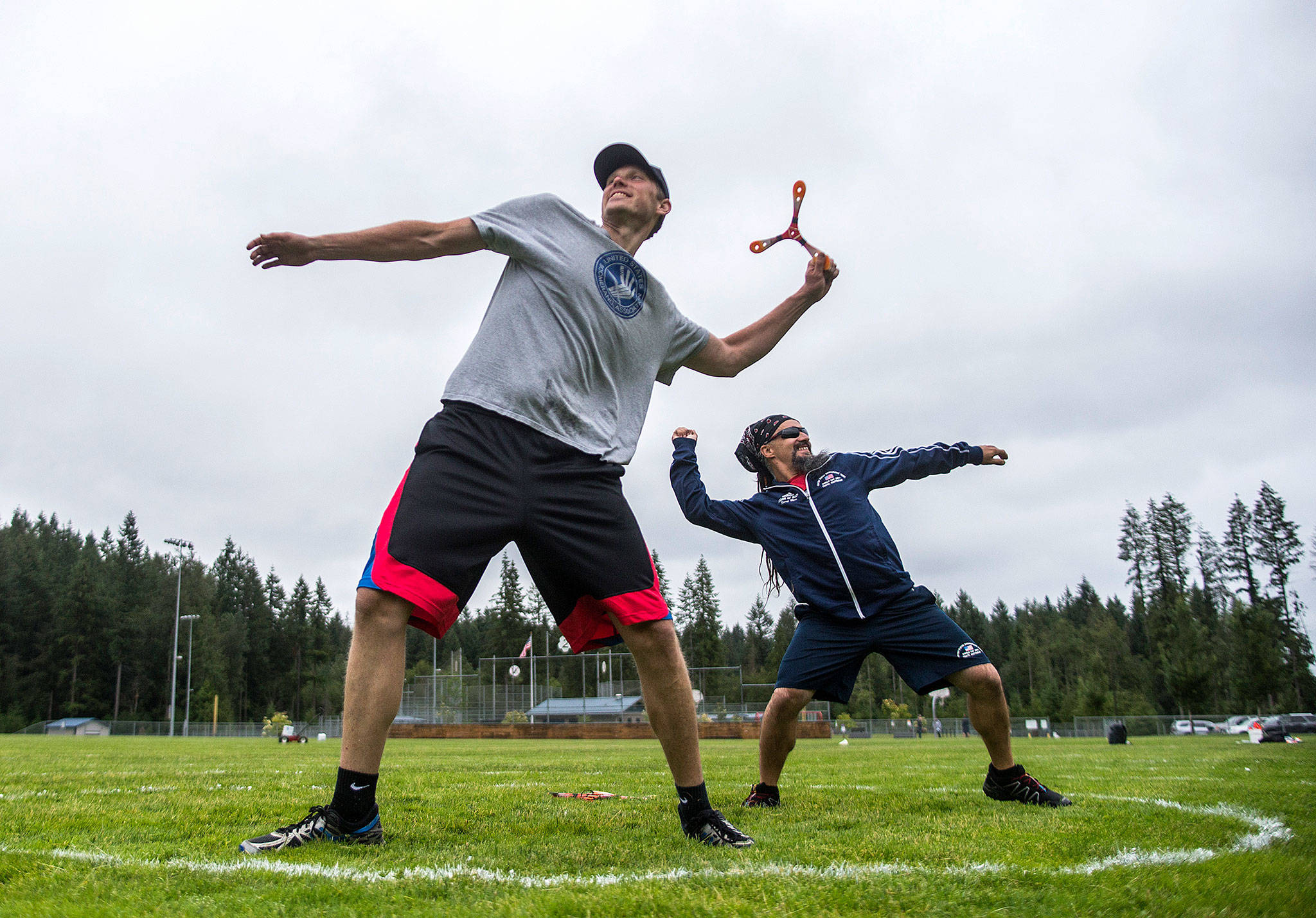 James Stickney, left, and Kenny Barr warm up before long distance boomerang throwing at Lake Stevens Community Park on Friday, June 22, 2018. (Olivia Vanni / The Herald)