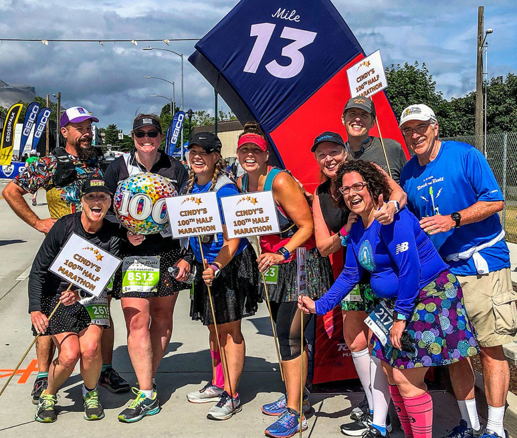 Cindy Ward (holding “100” balloon) with her running friends and family after completing her 100th half marathon in Seattle earlier this month. Her aunt, Gretchen Tapp (front left), who has run 140 half marathons and the Boston Marathon, was Ward’s inspiration. (Photo courtesy Cindy Ward and Gretchen Tapp)

