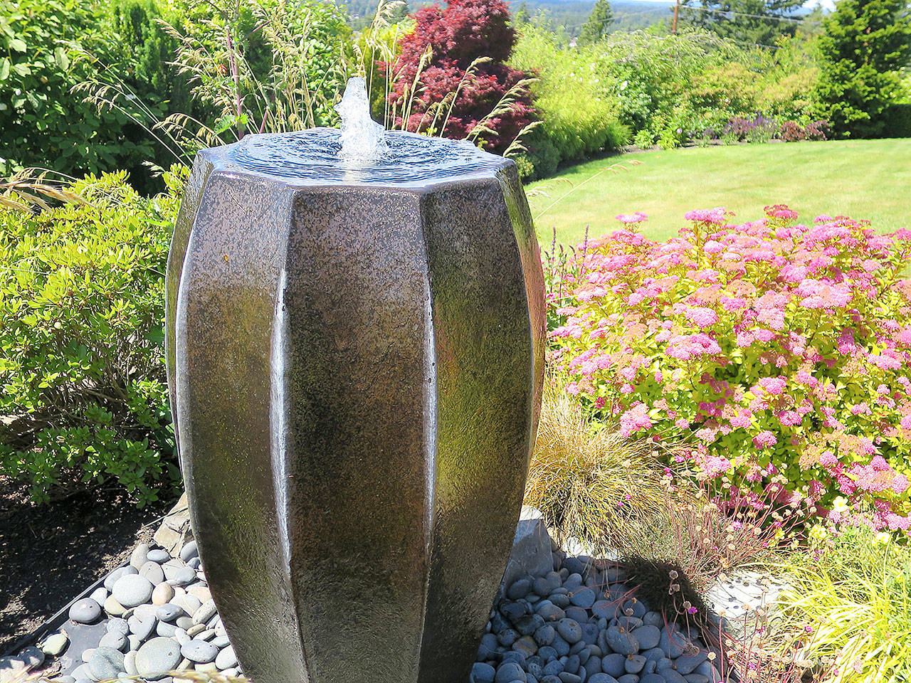 Vases are an affordable way to incorporate a water feature in the garden. (Pam Roy)