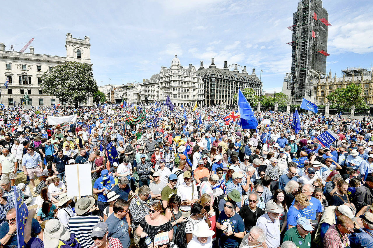 Crowds arrive in Parliament Square in central London during the People’s Vote march for a second EU referendum on Saturday, which was the two-year anniversary of the referendum that resulted Britain’s decision to quit the 28-nation EU. (John Stillwell/PA via AP)