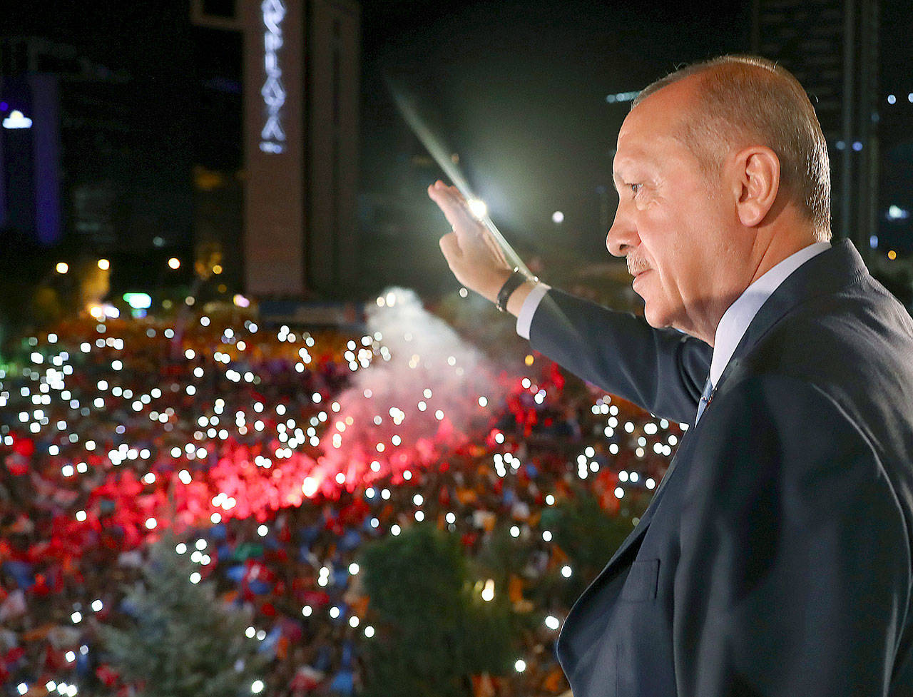 Turkish President Recep Tayyip Erdogan waves to supporters of his ruling Justice and Development Party in Ankara, Turkey, early Monday. (Presidency Press Service via AP, Pool)