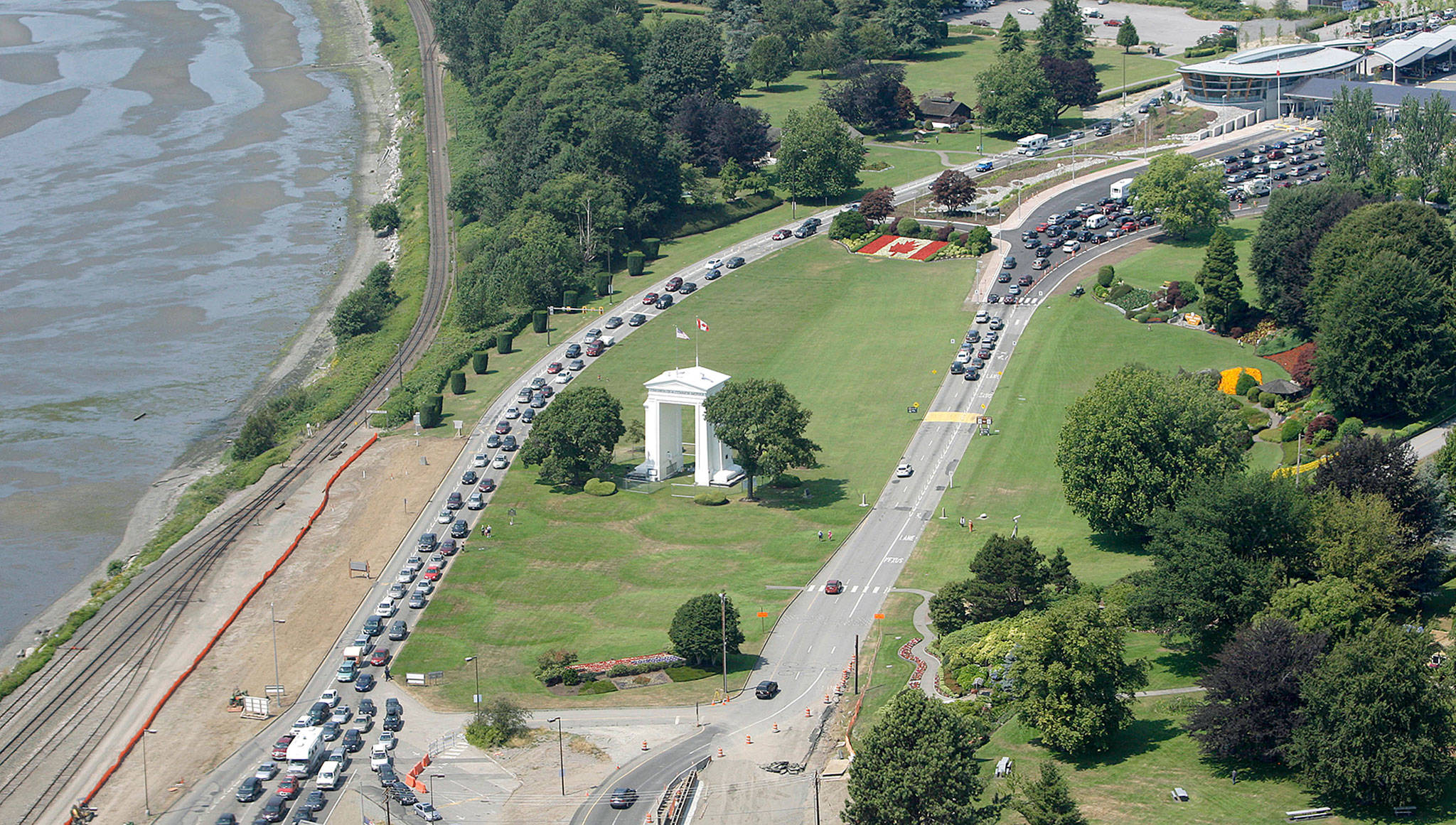 Cars line up heading into the United States (bottom) and into Canada (top) adjacent to the Peace Arch and Boundary Bay at a border crossing at Blaine. A 19-year-old woman who traveled from France to Canada to visit her mother in British Columbia says U.S. officials detained her for two weeks after she accidentally crossed the border while jogging. (Elaine Thompson / Associated Press)