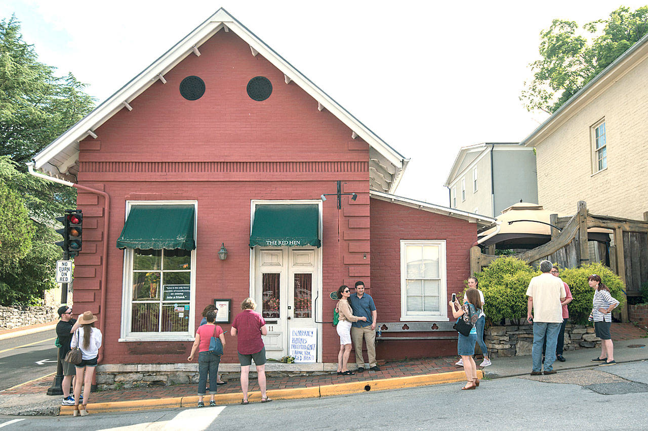 Passersby gather to take photos in front of the Red Hen Restaurant in Lexington, Virginia, on Saturday. (AP Photo/Daniel Lin)
