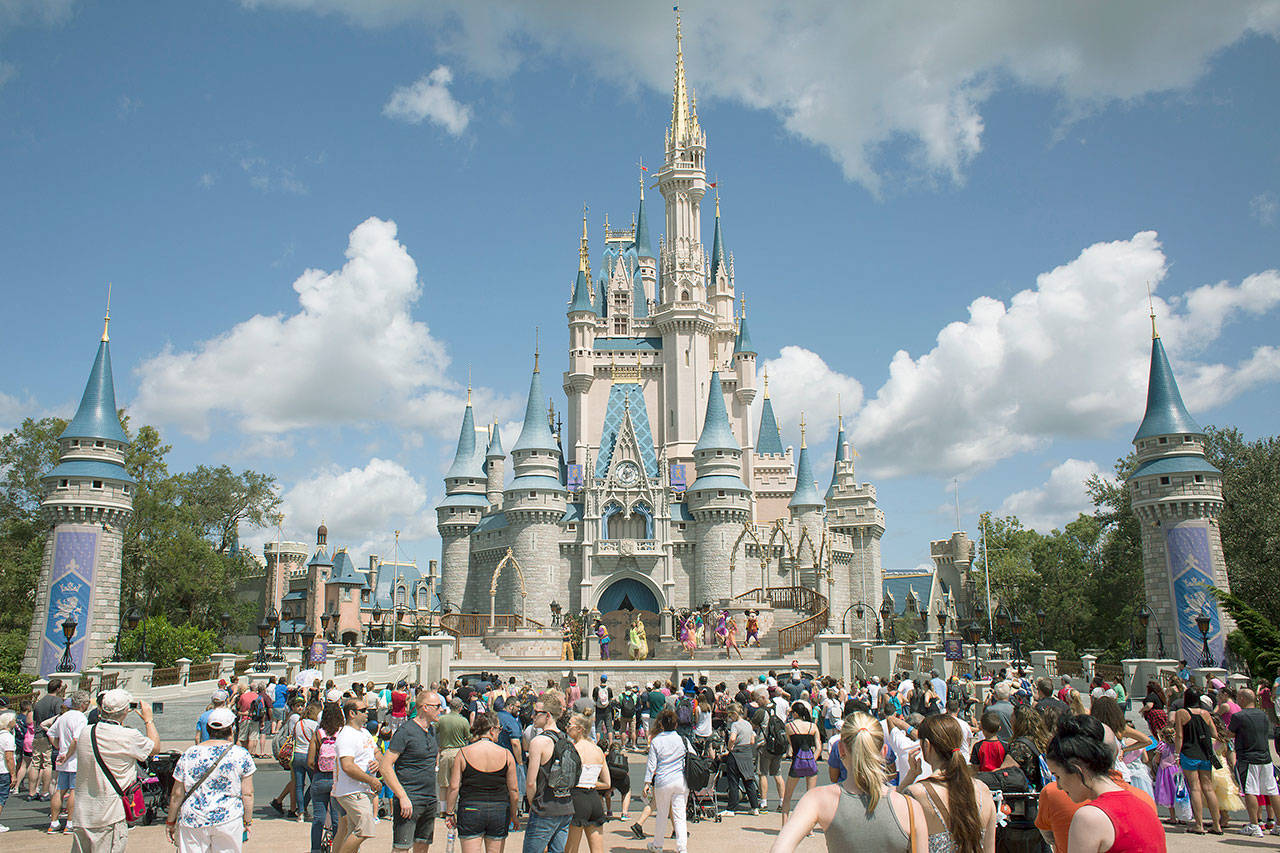 Visitors watch a performance Sept. 12 at the Cinderella Castle at the Walt Disney Co. Magic Kingdom park in Orlando, Florida. (Bloomberg photo by David Ryder)