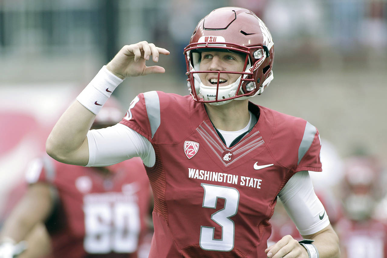 In this Sept. 2016 photo, Washington State quarterback Tyler Hilinski runs onto the field with his teammates before an NCAA college football game against Idaho in Pullman. (AP Photo/Young Kwak, File)
