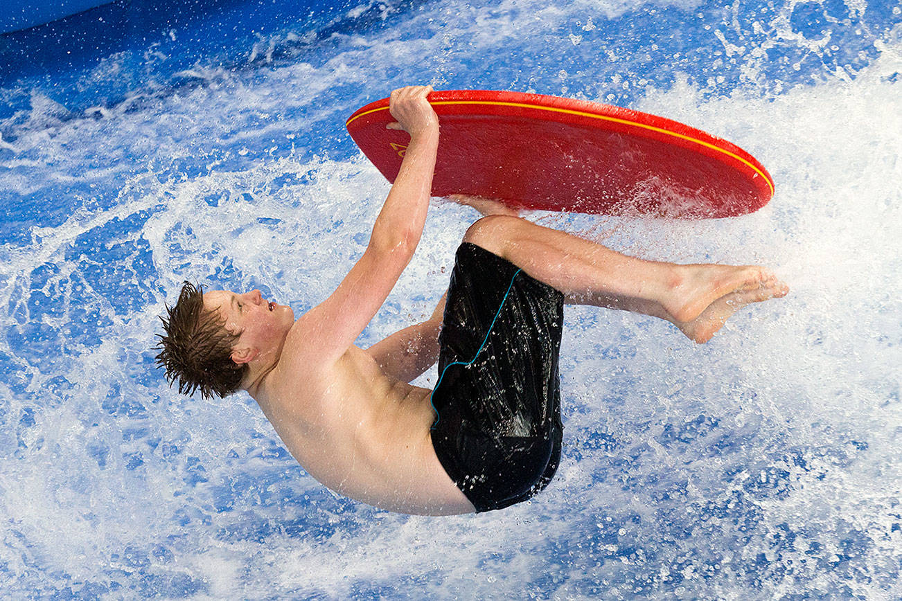 In preparation for the FlowRider Pro/Am competition on Saturday, flowboarder Aiden Fox-Bailey, 15, barrel rolls a bodyboard at the Snohomish Aquatic Center on Thursday, June 28, 2018 in Snohomish, Wa. (Andy Bronson / The Herald)