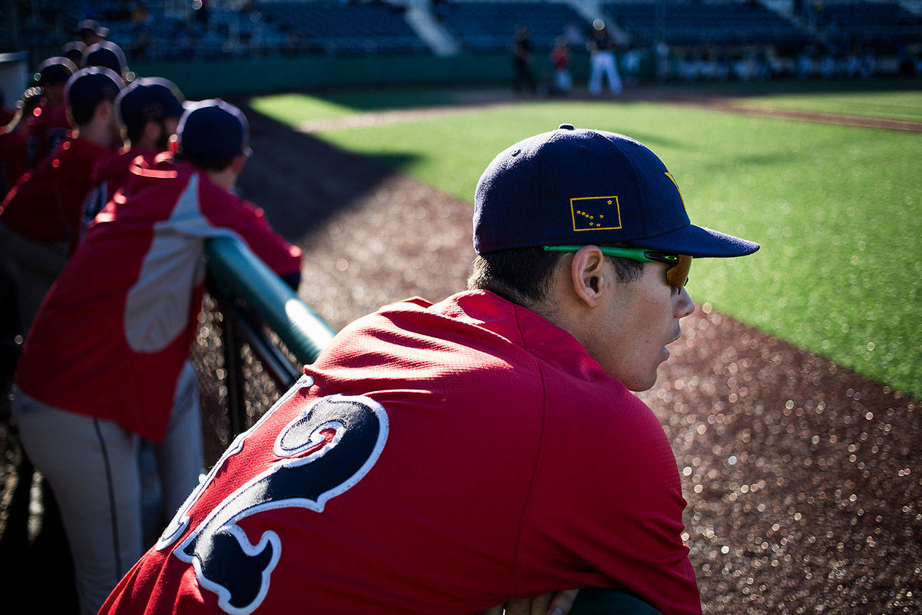 An Alaska state flag decorates the hat of Kyle Knell as he watches his team, the Goldpanners, play the first game of a three-game series against the Everett Merchants at Everett Memorial Stadium on Tuesday, June 26, 2018 in Everett, Wa. (Andy Bronson / The Herald)