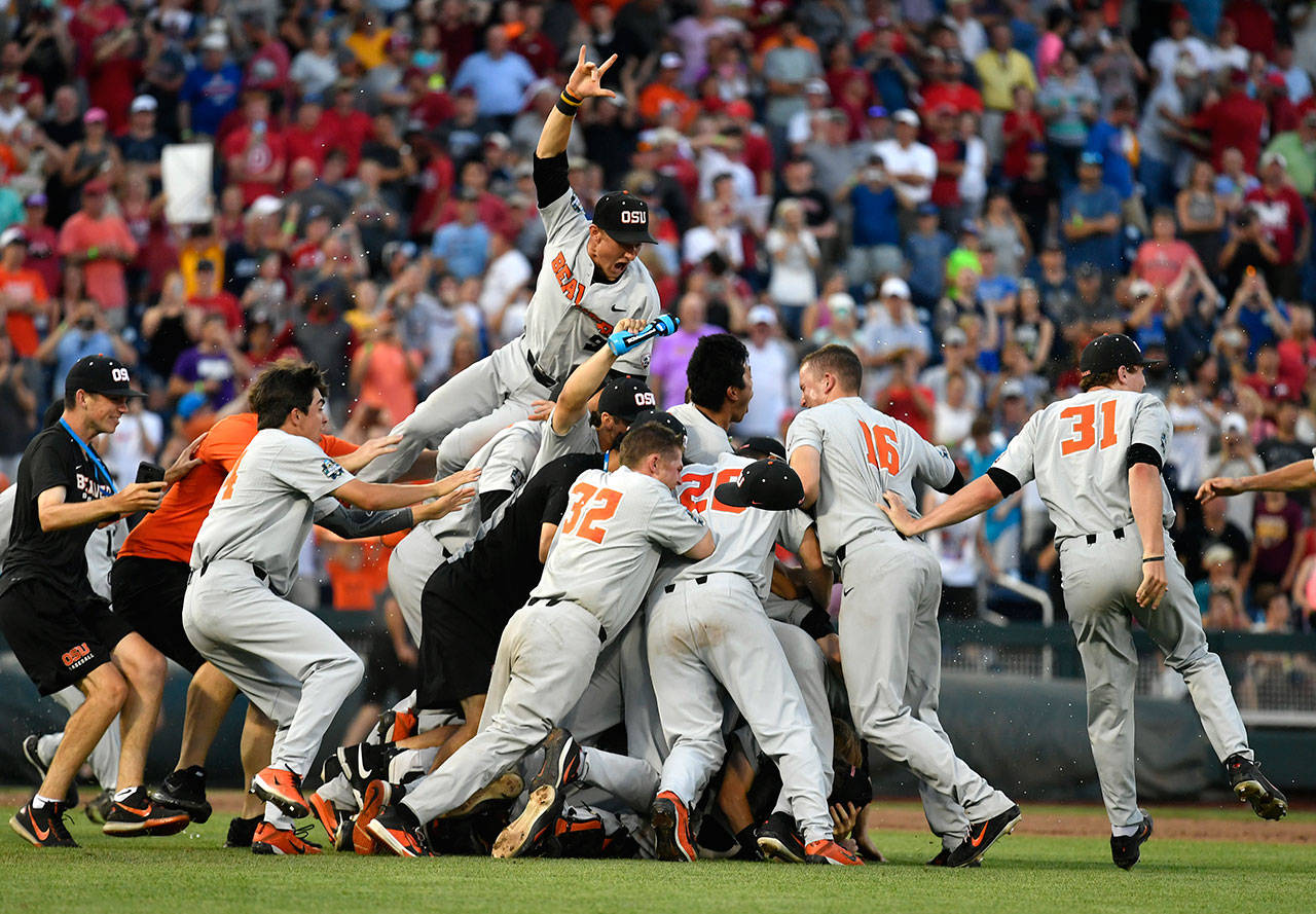 Oregon State players celebrate after beating Arkansas 5-0 in Game 3 of the NCAA College World Series finals to win the national championship on June 28, 2018, in Omaha, Neb. (AP Photo/Ted Kirk)