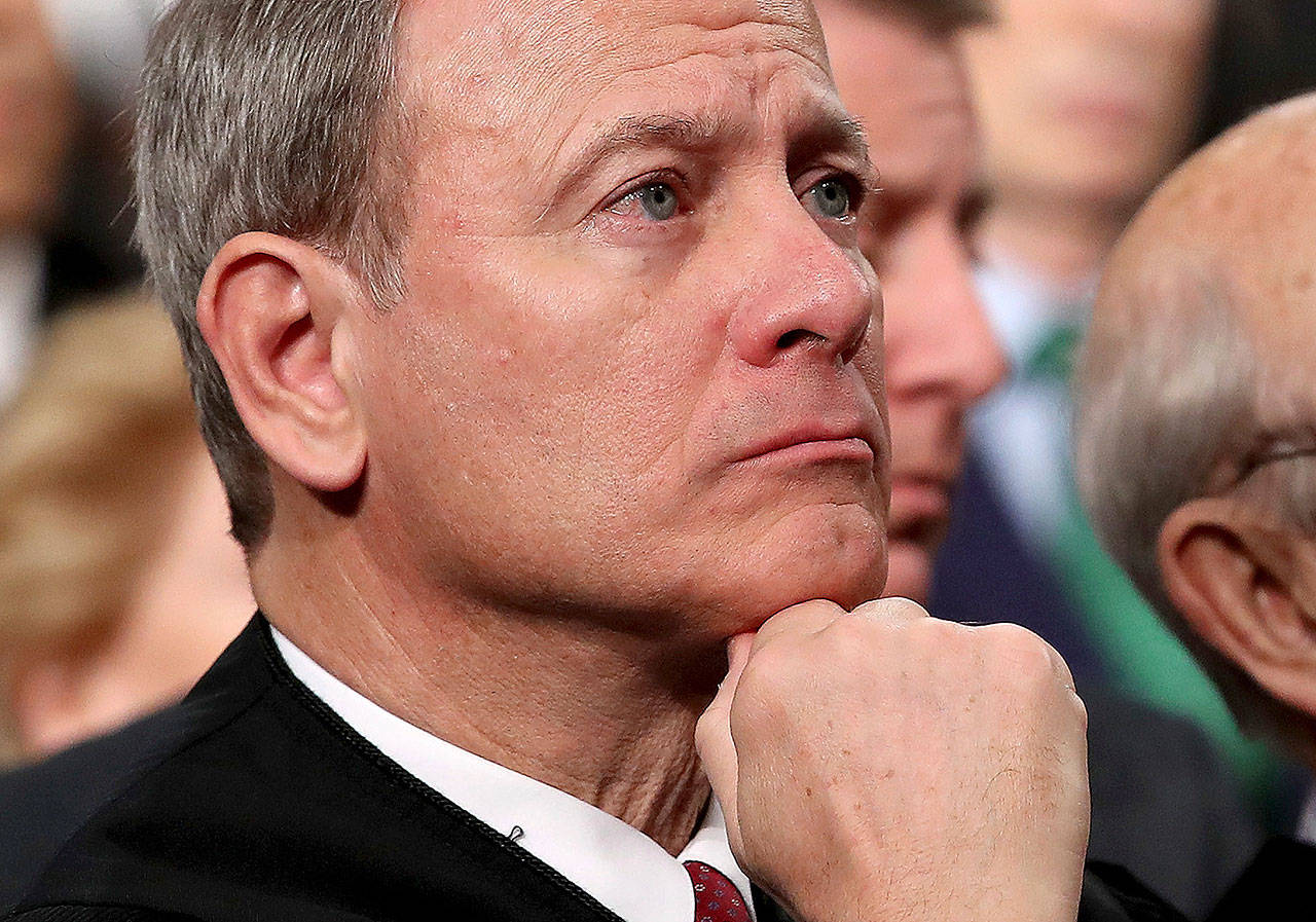 U.S. Supreme Court Chief Justice John Roberts listens as President Donald Trump delivers his first State of the Union address in January. (Win McNamee)