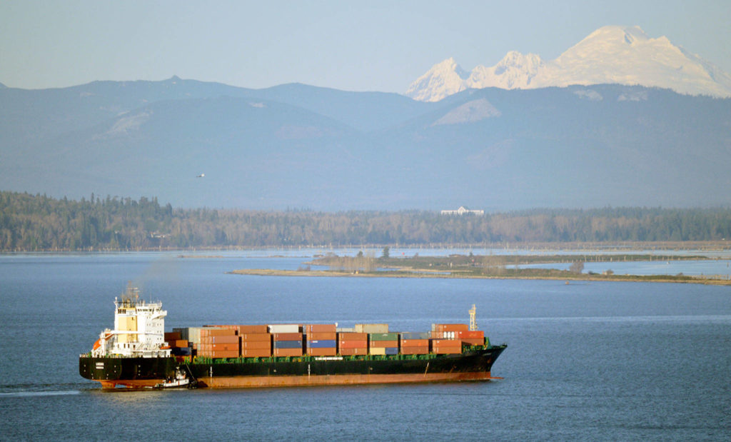 With Mount Baker and Jetty Island in the distance, a container ship approaches the Port of Everett. (Port of Everett) 
