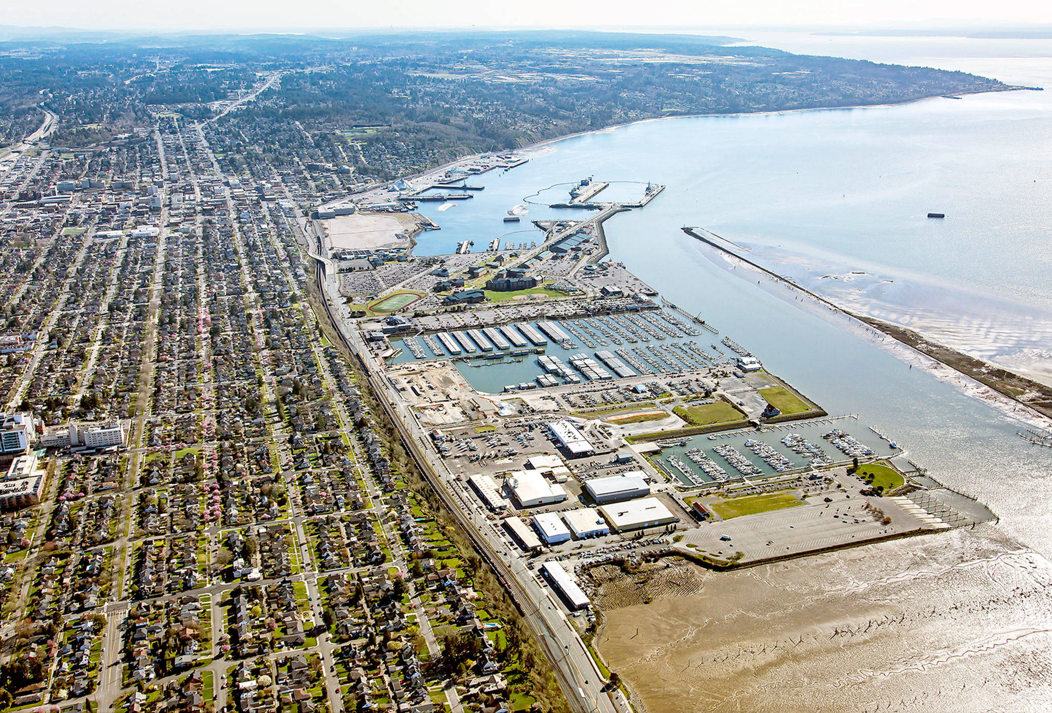 Looking south, the Everett waterfront. The Port of Everett’s seaport area is at the top, and the port’s other properties, including the marina, are in the center and bottom of the picture. The fork-shaped pier and the land it connects to is Naval Station Everett. (Port of Everett)