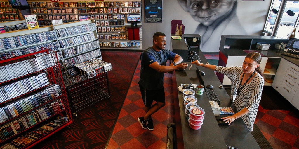 Dan Bates / The Herald
Yvonne Seeber, 43, who has worked at Silver Lake Video for 18 years, handles a purchase by Ashraf Mabrouk, of Everett. Mabrouk says he likes this store and has been a customer for 10 years.
