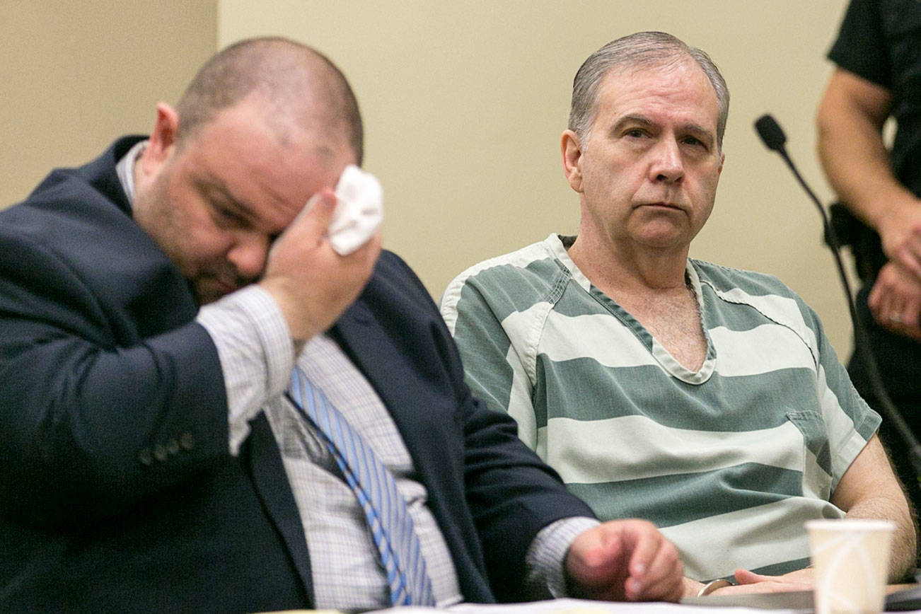 John Reed (right) awaits sentencing with attorney Phil Sayles at the Snohomish County Courthouse in Everett on Friday. Reed was sentenced to life in prison for the double murder on his neighbors in Oso in 2014. (Kevin Clark / The Herald)