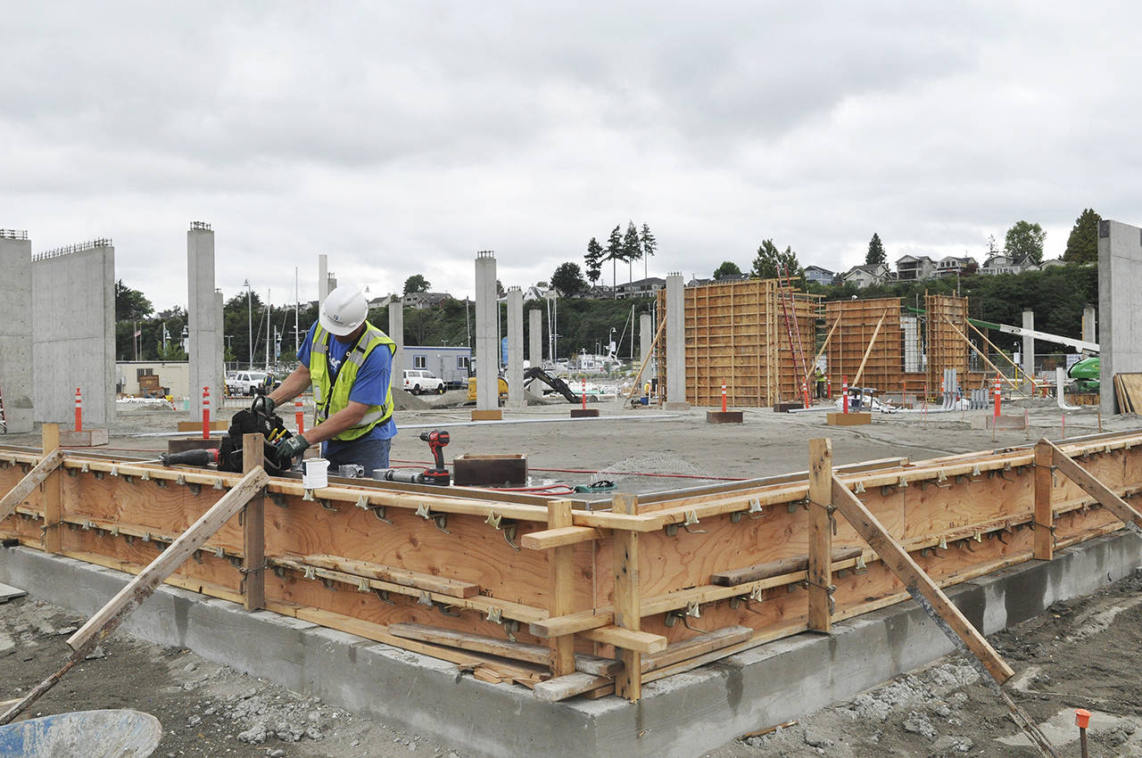 Electrician Chris Lilleberg works on the forms at the construction site of the Port of Everett’s Waterfront Place Central redevelopment project. (Sue Misao / The Herald)