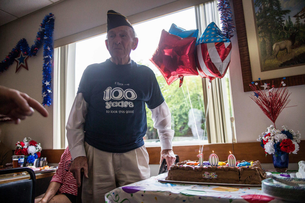 Edgar Shepherd stands next to his birthday cake during his 100th birthday celebration at the Lynnwood Elks Lodge on Wednesday. (Olivia Vanni / The Herald)
