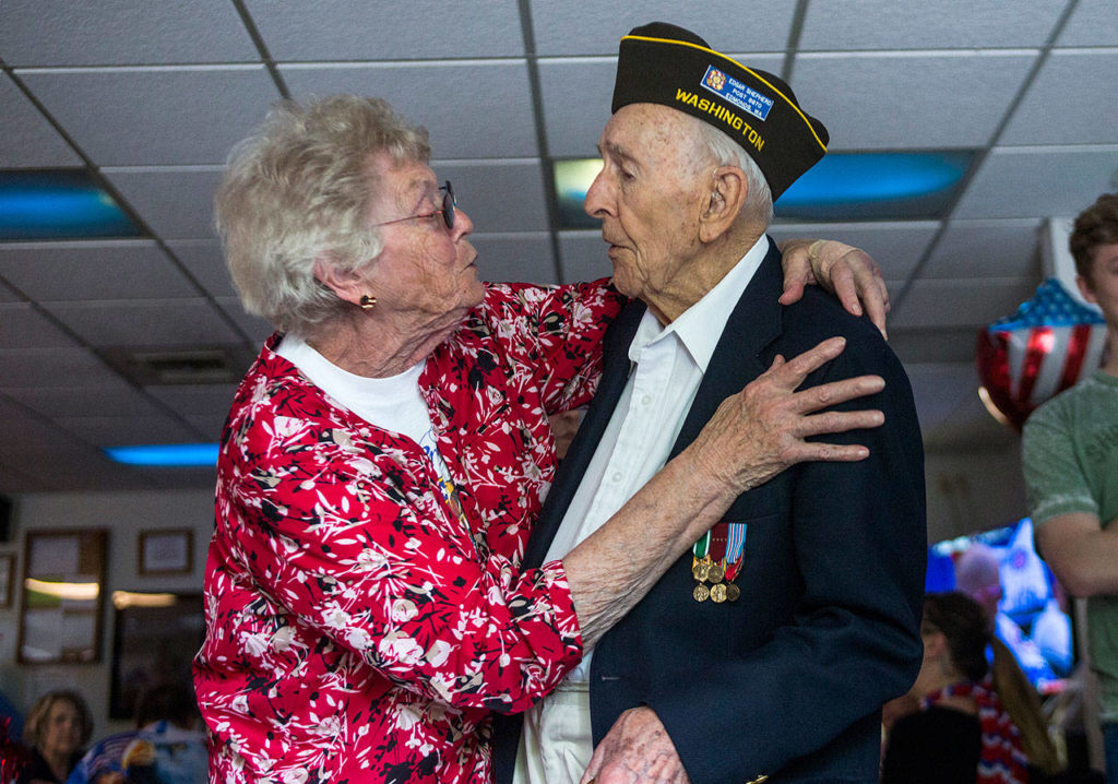 Brenda Passeau (left) hugs Edgar Shepherd at his 100th birthday celebration at the Lynnwood Elks Lodge on Wednesday. (Olivia Vanni / The Herald)
