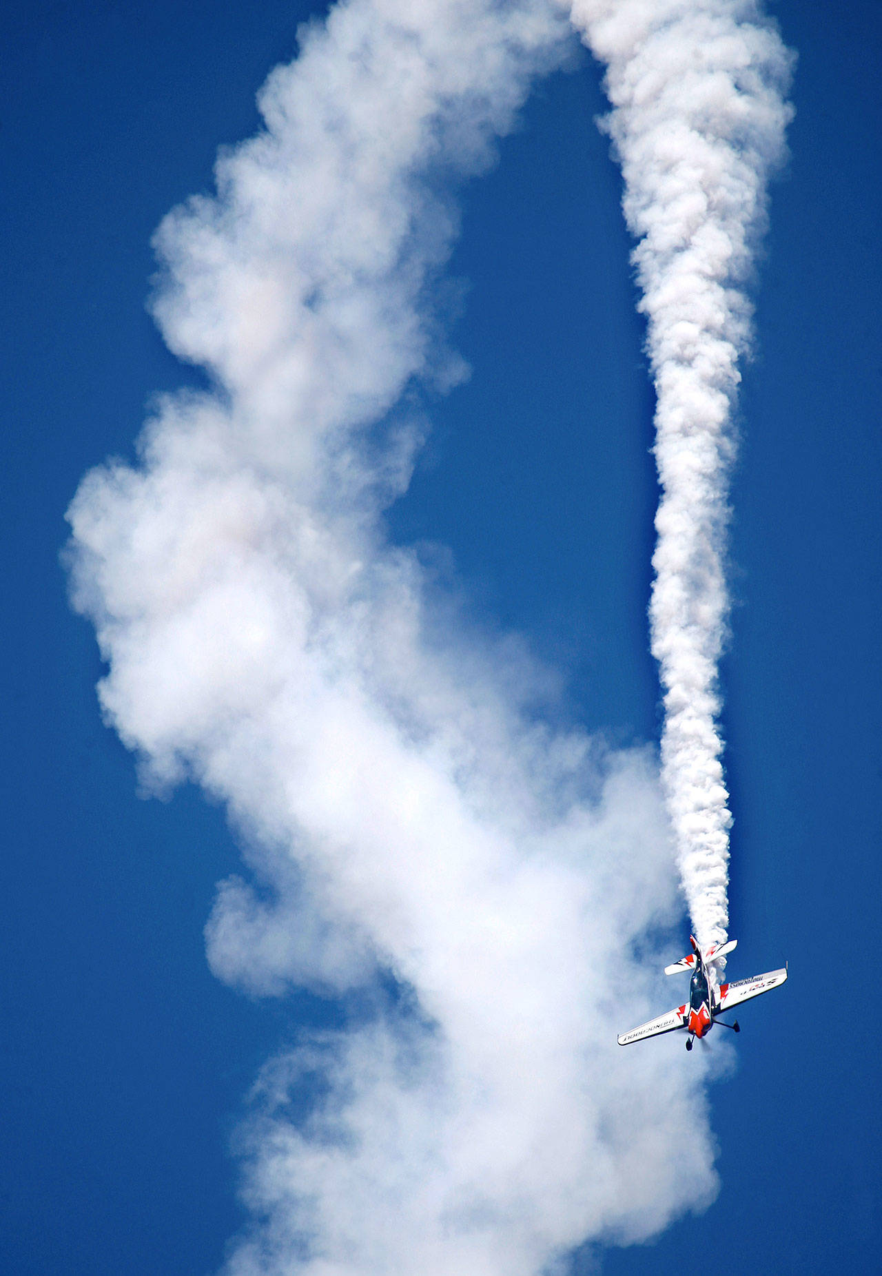 Stunt pilot Doug Jardine makes some spectacular moves in his Sbach 342 at the 2012 Arlington Fly-In. (Dan Bates / Herald file)