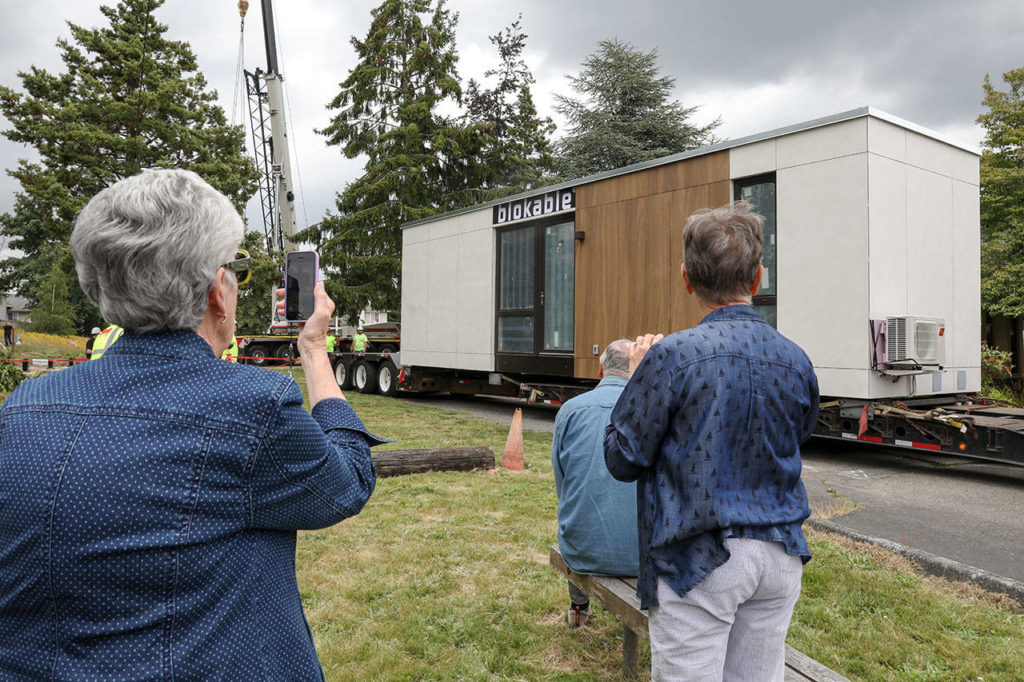 Members of Edmonds Lutheran Church gather watch the first Blok unit be placed on church grounds. (Lizz Giordano / The Herald)
