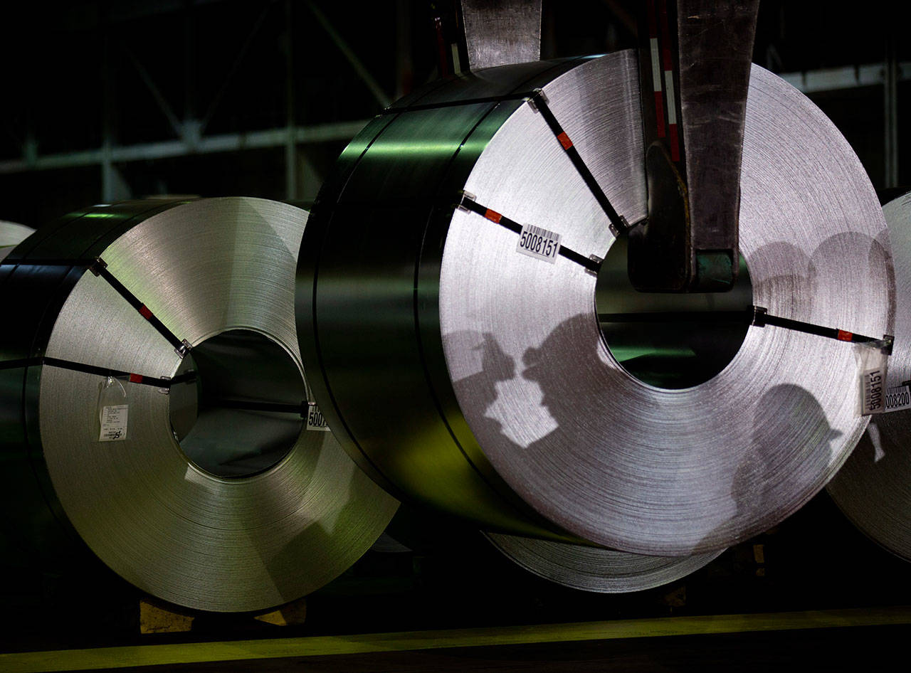 Shadows of workers are reflected on rolls of coated steel Friday, June 29, at Stelco in Hamilton, Ontario. Canada announced billions of dollars in retaliatory tariffs against the U.S. on Friday in a tit for tat response to the Trump administration’s duties on Canadian steel and aluminum. (Peter Power/The Canadian Press via AP)