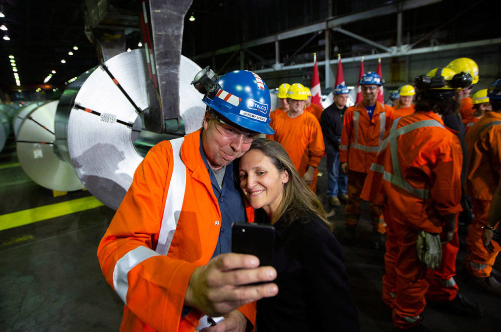 Jeremy Spence, an area manager in cold rolling at Stelco, takes a selfie with Chrystia Freeland, Minister of Foreign Affairs, visited Stelco in Hamilton, Ontario, Friday, June 29. Canada announced billions of dollars in retaliatory tariffs against the U.S. on Friday in a tit for tat response to the Trump administration’s duties on Canadian steel and aluminum. (Peter Power/The Canadian Press via AP)
