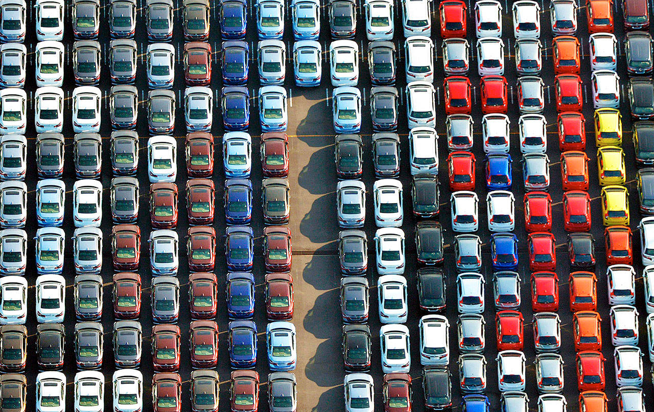 Cars are parked waiting to be exported near Tokyo. (Kyodo News via AP)