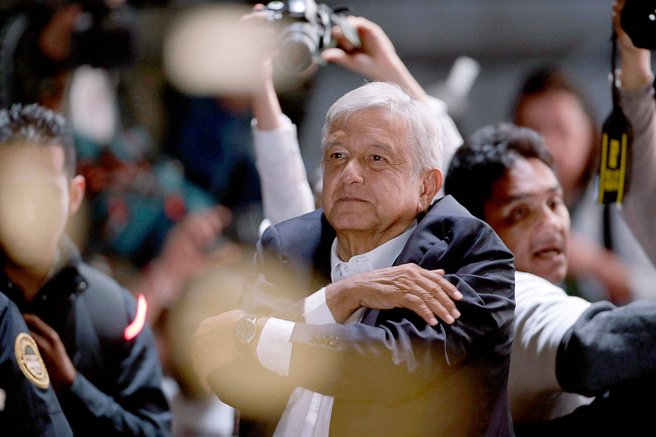 Presidential candidate Andres Manuel Lopez Obrador acknowledges supporters as he arrives at Mexico City’s main square on Sunday. (AP Photo/Moises Castillo)