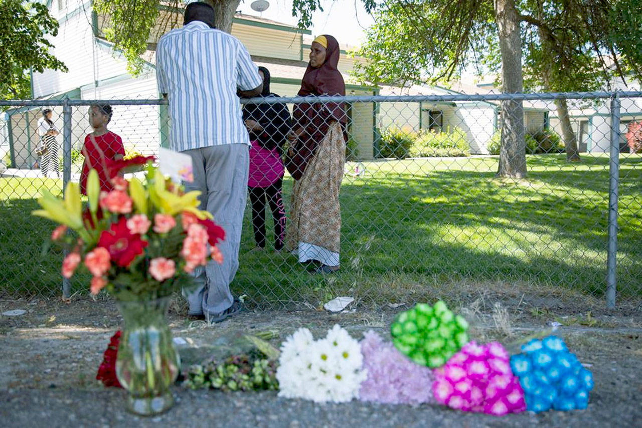 Ibod Hasn (center) talks to a friend who came to visit Sunday after Saturday’s stabbing attack in Boise. (Meiying Wu/Idaho Statesman via AP)