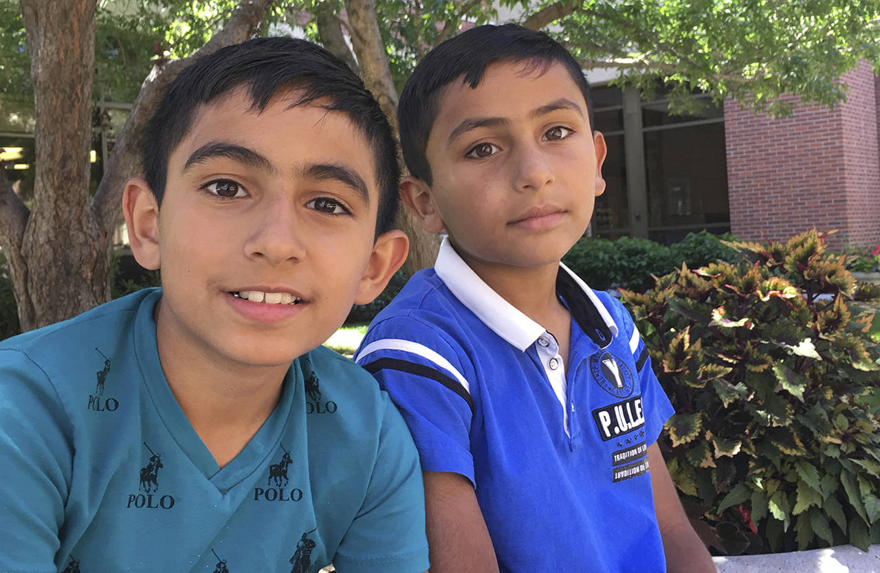 Zine Jalil, right, 8, and Siraj Jalil, 9, pose for a photo as they visited their mother and sister in St. Luke’s Boise Medical Center in Boise, Idaho, on Monday, after they were attacked while attending a girl’s birthday party Saturday. (Maria L. La Ganga/Idaho Statesman via AP)