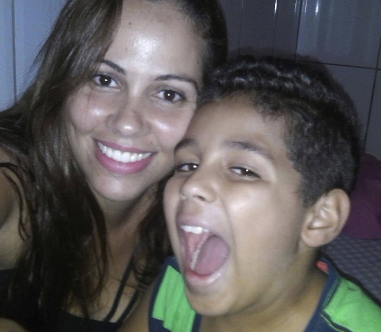 This undated photo provided by Lidia Karine Souza via her attorney Lidia posing for a photo with her son Diogo De Olivera Filho. The mother from Governador Valadares, Brazil has filed a federal lawsuit demanding the release of her 9-year-old son who’s being detained in Chicago after the two were separated at the border. (Courtesy of Lidia Karine Souza via AP)