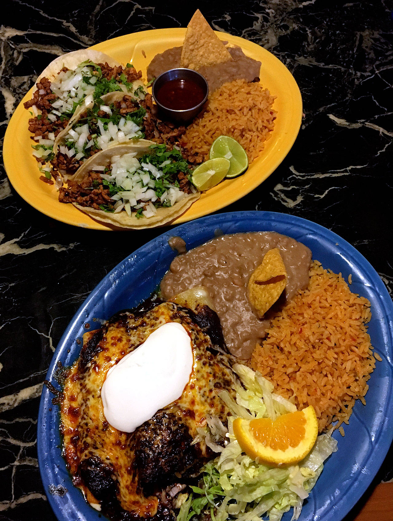 Tacos al pastor (top) and enchiladas in the house mole sauce make a feast for two — with leftovers — at Casa Guerrero, which has a Lynnwood address, but is on 164th Street SW, just southeast of Martha Lake. (Sarah Serpanos)