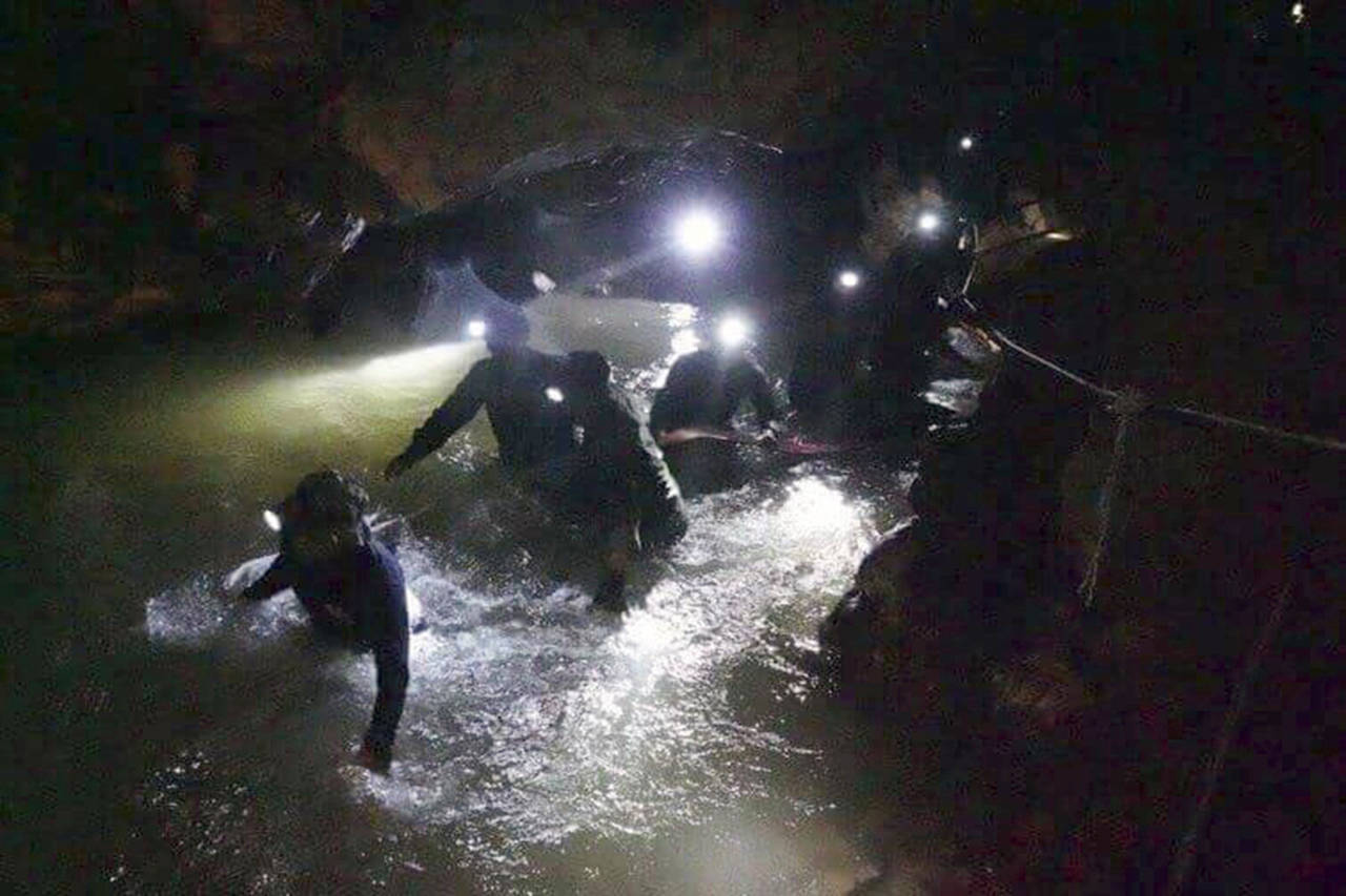 Thai rescue teams walk inside cave complex where 12 boys and their soccer coach went missing, in Mae Sai, Chiang Rai province, in northern Thailand on Mon, July 2, 2018. Rescue divers are advancing in the main passageway inside the flooded cave in northern Thailand where the boys and their coach have been missing more than a week. (Tham Luang Rescue Operation Center via AP)