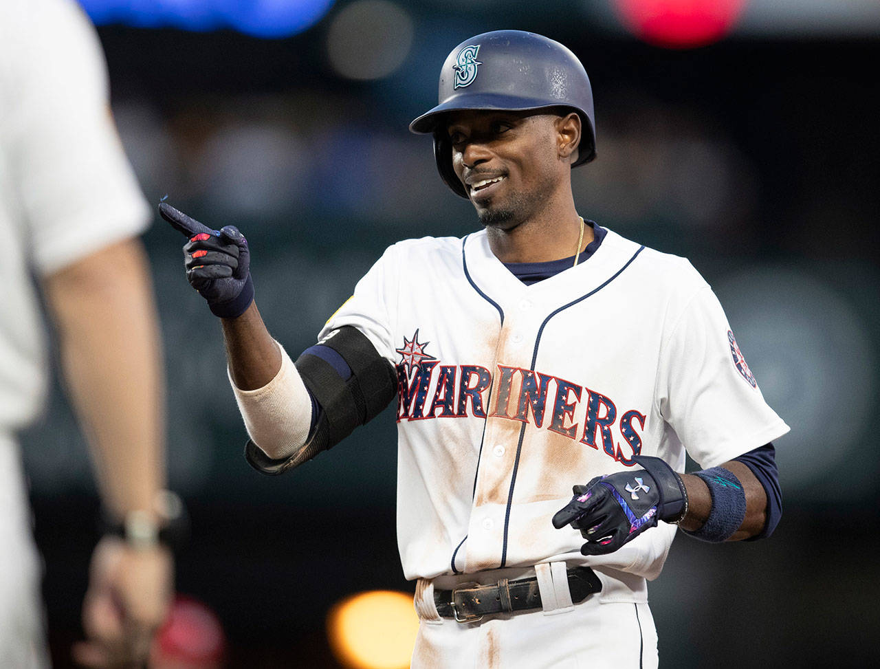 The Mariners’ Dee Gordon gestures to the dugout after hitting a single during a game against the Angels on July 3, 2018, in Seattle. (AP Photo/Stephen Brashear)