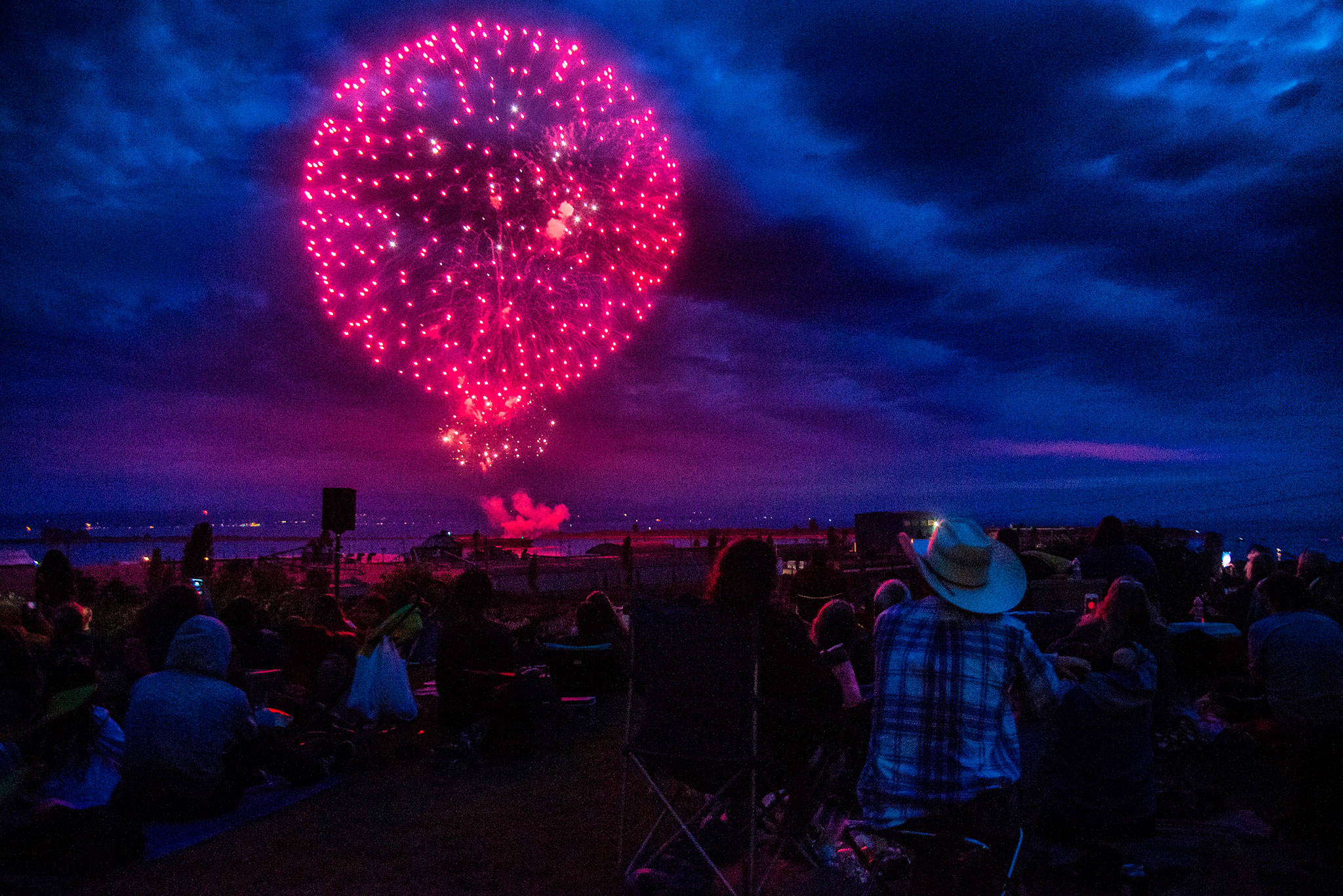 People gather to watch the Thunder on the Bay Fireworks display from Legion Memorial Park on Wednesday in Everett. (Olivia Vanni / The Herald)