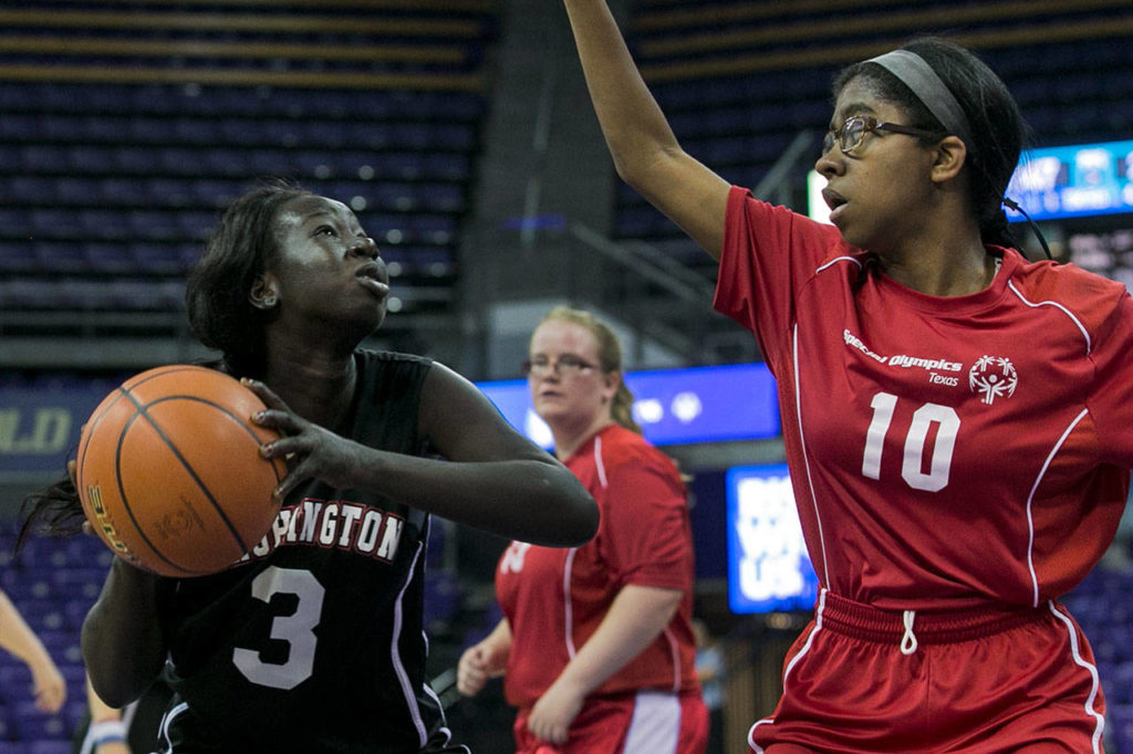 Washington’s Agwin Atem (left) attempts a shot with Texas’ Alandria Rivera defending during the female basketball gold-medal game at the 2018 Special Olympics USA Games on July 5, 2018, at Alaska Airlines Arena in Seattle. (Kevin Clark / The Herald)
