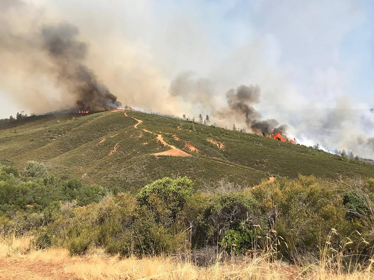 The Pawnee Fire wildfire, burning here on Sunday northeast of Clearlake Oaks, California, was one of four wildfires in largely rural areas as wind and heat gripped a swath of California from San Jose to the Oregon border. (Jonathan Cox/California Department of Forestry and Fire Protection via AP)