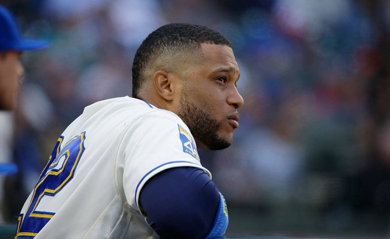 The Mariners’ Robinson Cano watches from the dugout during a game against the Indians on Sept. 24, 2017, in Seattle. (AP Photo/Ted S. Warren)