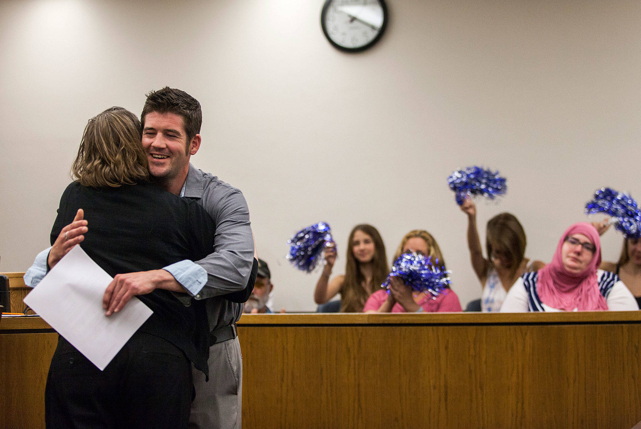 Eric Brossard receives a hug during drug court graduation as family and friends cheer in support at the Snohomish County Superior Court on Friday in Everett. (Olivia Vanni / The Herald)