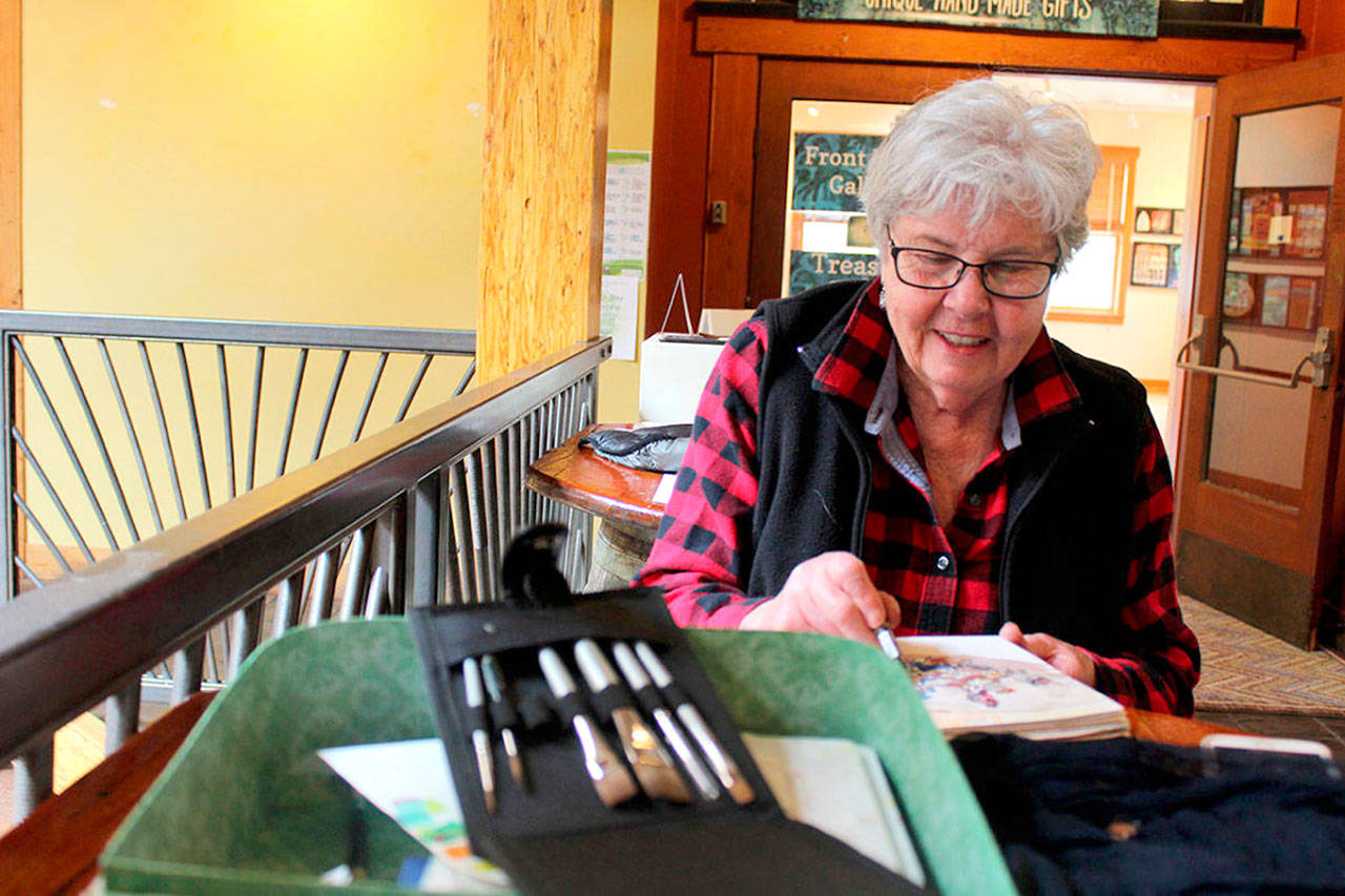 Pat Brookes said she didn’t know how to draw or paint before attending Whidbey Island Sketchers weekly meetings. Now she keeps track of her travels with on-the-scene sketches. (Photo by Patricia Guthrie / Whidbey News Group)