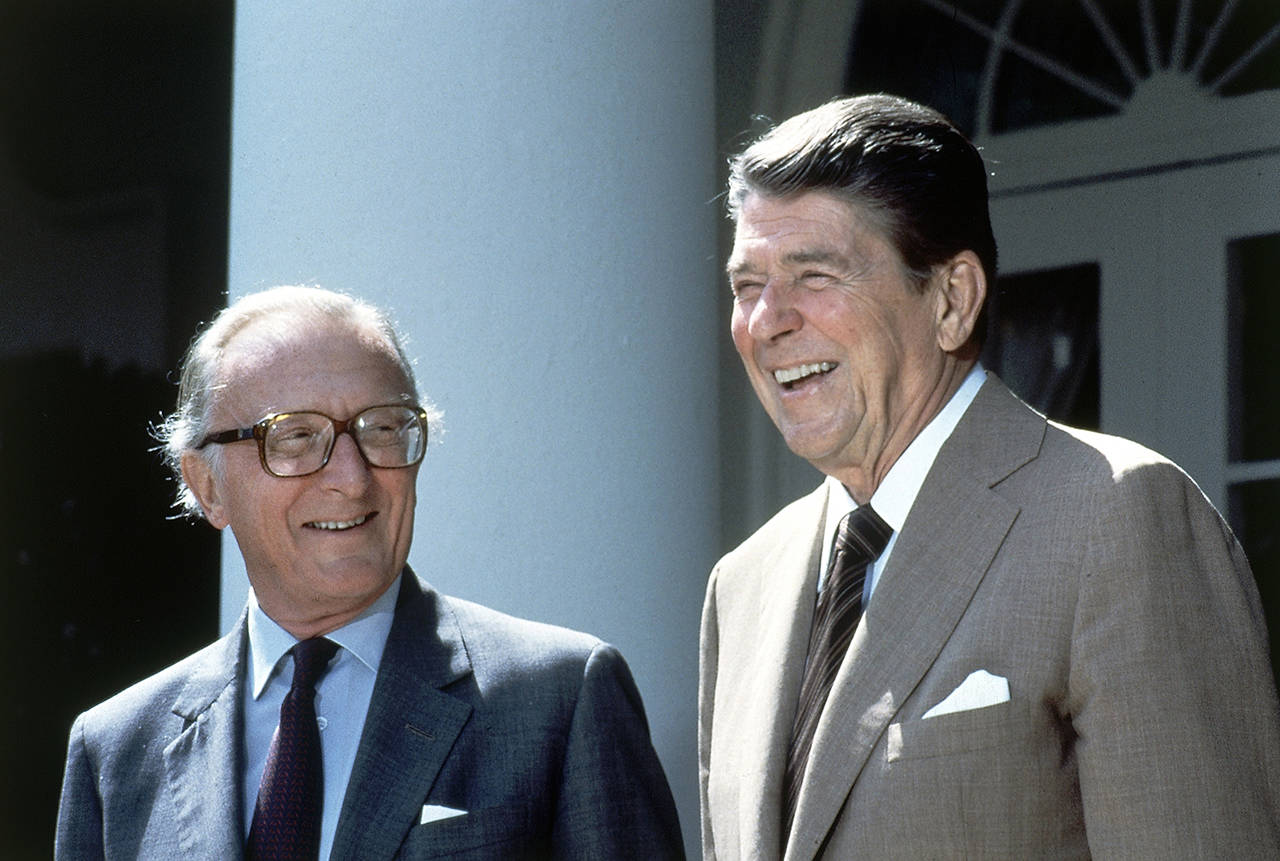 In this Sept. 11, 1984 photo, President Ronald Reagan and NATO Secretary General Lord Carrington pose for photographers in the Rose Garden prior to talks at the White House in Washington, D.C. (AP Photo/Barry Thumma, FILE)