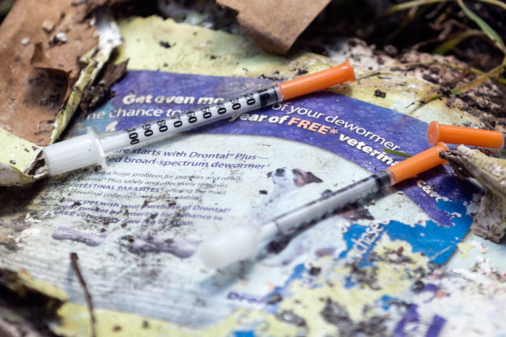 Needles are part of the detritus at a nuisance house near Woodinville on July 11, 2018. (Kevin Clark / The Herald)
