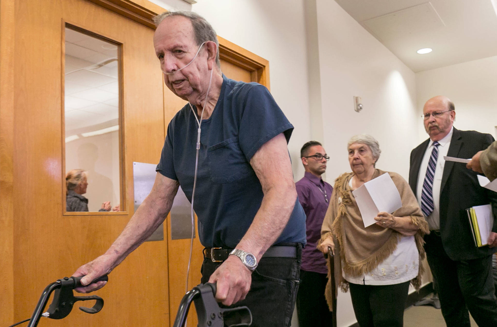 Clyde (left) and Faye Reed make their way into the courtroom Thursday in Everett, where they pleaded guilty to helping their son flee after he killed his two Oso neighbors. (Kevin Clark / The Herald)