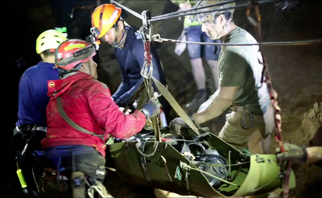 Rescuers hold an evacuated boy inside the Tham Luang Nang Non cave in Mae Sai, Chiang Rai province, in northern Thailand. (Thai NavySEAL Facebook Page via AP)