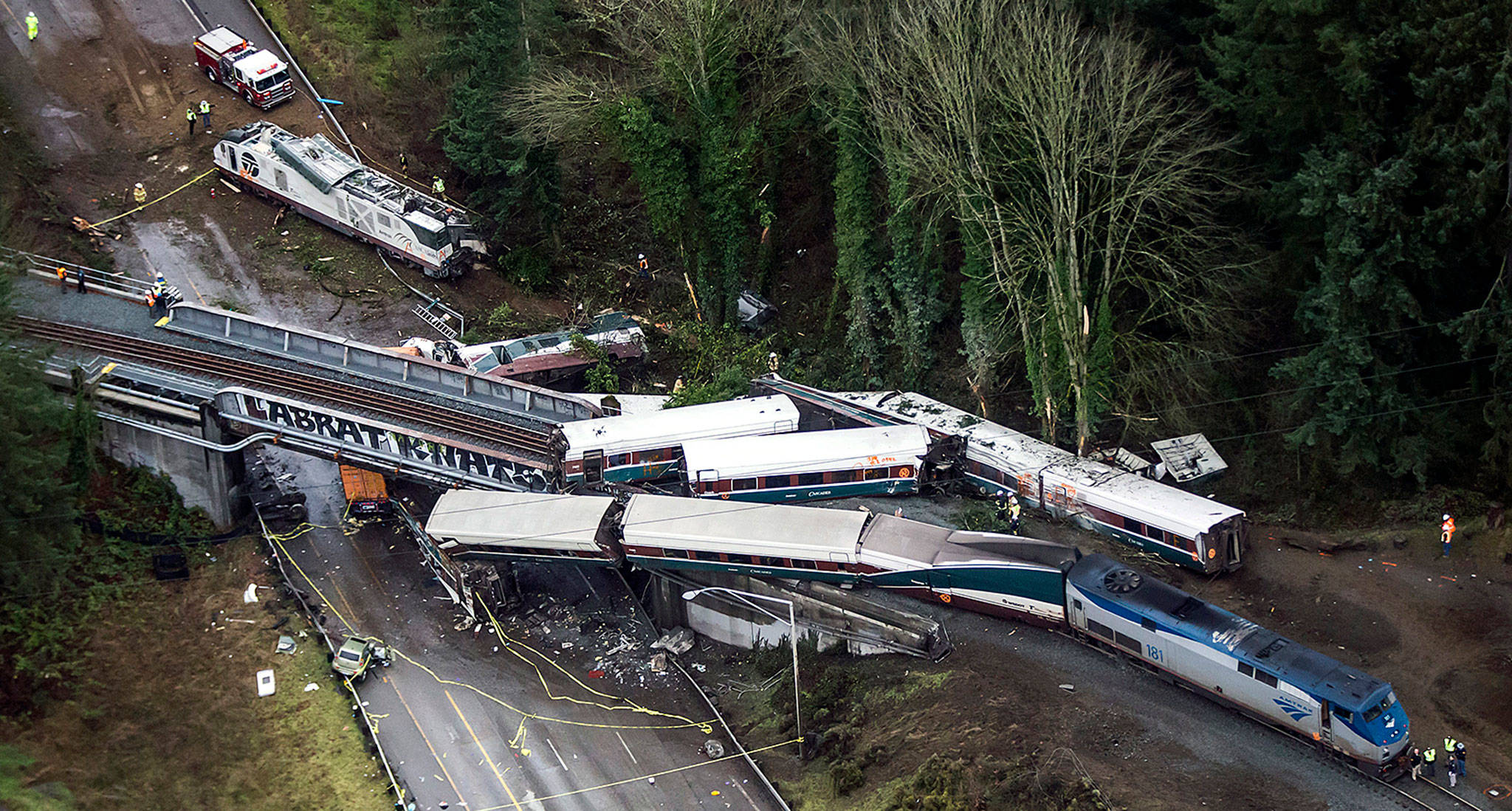 Cars from an Amtrak train that derailed lie spilled onto I-5 on Dec. 18, 2017, near DuPont. (Bettina Hansen/The Seattle Times via AP)