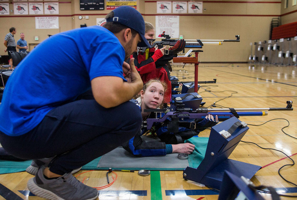 Sydney McKay listens as Shelby Huber gives her tips to improve her shooting during the CMP Air Rifle Marksmanship Camp at Snohomish High School on Thursday in Snohomish. (Olivia Vanni / The Herald)
