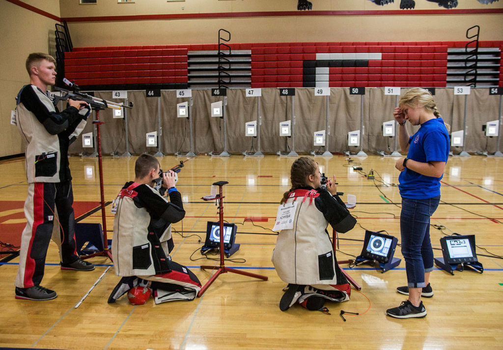 Maddie Korthas (right) talks to a camper during CMP Air Rifle Marksmanship Camp at Snohomish High School on Thursday. (Olivia Vanni / The Herald)
