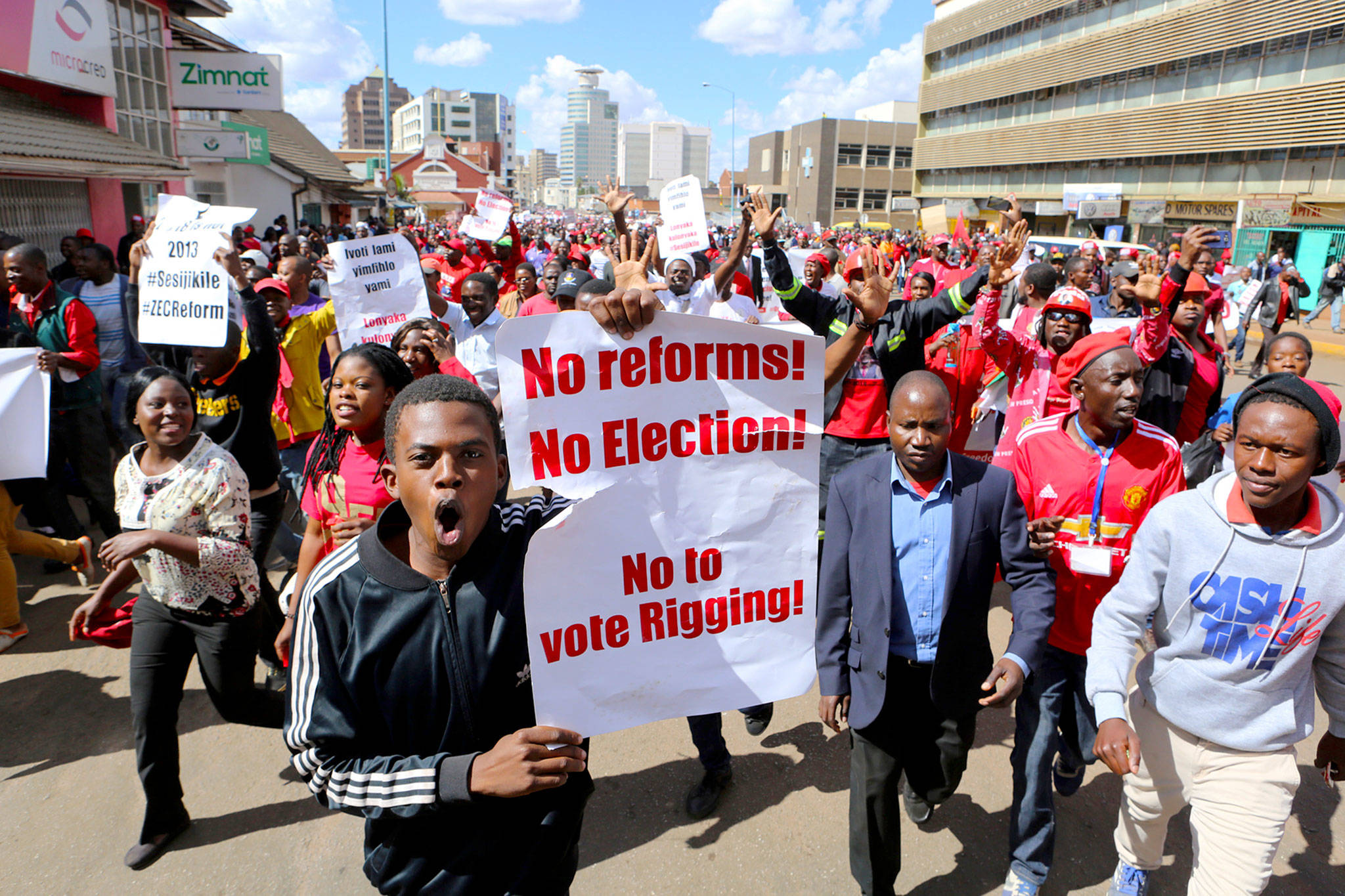 Thousands of opposition party supporters march on the streets of Harare on Wednesday. (AP Photo/Tsvangirayi Mukwazhi)