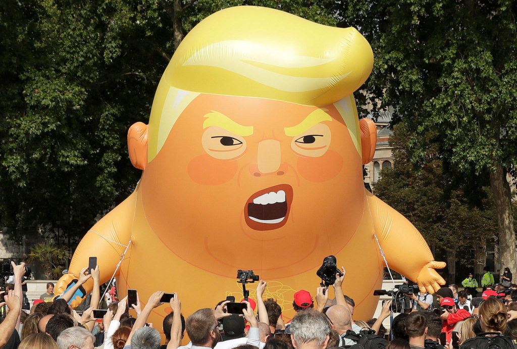 A six-meter high cartoon baby blimp of U.S. President Donald Trump is flown in Parliament Square of London on Friday as a protest against his visit. (AP Photo/Matt Dunham)
