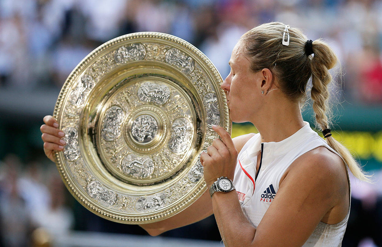 Angelique Kerber kisses the trophy after winning the women’s singles final Saturday against Serena Williams at Wimbledon in London. (Tim Ireland / Associated Press)